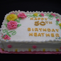 50Th Birthday Cake Whipped cream icing decorated with whipped buttercream roses, decorations & borders with fondant lettering & edible twinkle dust....