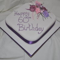 60Th Birthday a simple design with purple/pink flower spray and small design as edging