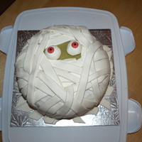 Yummy Mummy Cake Vanilla Cake crumbcoated with buttercream and covered with marshmallow fondant strips. It was a hit for my daughter's class halloween...