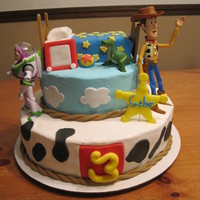 Toy Story Bed made of RCT. All toys and other accents made of fondant. Covered in BC.