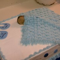 Baby Boy Shower Cake This cake is mostly buttercream with the exception of the the bibs and dots around the edge. The baby is made out of gumpaste and the...