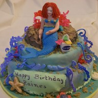 Mermaid Cake This was for an 11 year old young lady who likes mermaids. Cake is chocolate covered with fondant. Accents are made of hard candy, fondant...