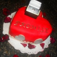 Promise Used 8" round pan and carved heart shape. Covered in fondant. Airbrused. Silver hearts are fondant also.