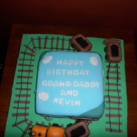 Train Cake French vanilla cake with vanilla frosting. Train and carts made from rice cereal treats. Fondant decoration.