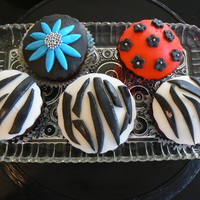 Cupcakes! This was my first attempt at designer cupcakes! They are chocolate cupcakes with fondant designs!