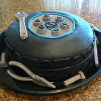 Tire Cake This cake is 100% edible. The tire is made from 2 10 inch rounds that I just shaped to a tire. The tools, nuts and screws are 100% edible...