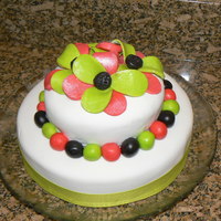 Flower Cake! The bottom is a 8x2 inch and the top is a 5x2 inch. The cake is covered in marshmallow fondant. The flowers and balls are made from fodant...