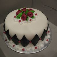 Hatfield.jpg Birthday cake done for my son's teacher. Chocolate cake with chocolate mousse. Covered in MMF, ribbon roses MMF and BC clouds