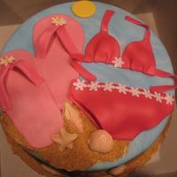 Beach Theme 10 in vanilla with raspberry filling. Covered in MMF and decorated in MMF