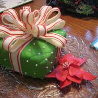 Christmas Present Chocolate cake covered in MMF. Bow and flower made with MMF. Enjoy!