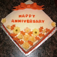 Fall Anniversary Cake This is a cake I made for coworker. It is red velvet cake with cream cheese frosting and fondant accents. Thanks for looking.