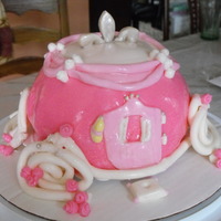 Princess Cake Based on a cake I saw here on cake central. I carved the shape out of a 11x15 split 3 ways. I had a lot of trouble with the wheels staying...