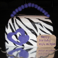 Purse Birthday Cake This is a yellow butter cake with buttercream icing and buttercream fondant zebra strips and decorations. This was my first 3D cake.