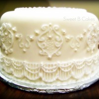 Anniversary Cake Lemon cake with lemon buttercream filling. MM fondant covering and piped accents. My first attempt at stringwork. Next time I wil use a...