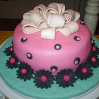 Pink Fondant Cake With Black Daisies Pink fondant cake with polka dots and black daisies and large gum paste bow, made as a final project in my Gum paste and Fondant class.