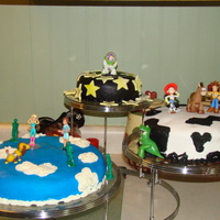 Toy Story 3 3 layered Toy Story cake. Small layer Yellow cake with Vanilla frosting covered in black Fondant with Yellow/white mixed fondant stars and...