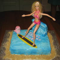 Surfing Barbie Cake This cake was for a 7-year-old girl who was having a Barbie in the Mermaid Tale party. She really wanted the actual Barbie to be surfing on...