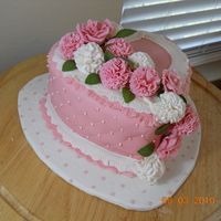 8" Heart W/carnations 8" heart with pink fondant, pink and white carnations and pink roses. Board and side of cake have diamond pattern with tiny white and...