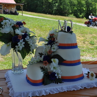 Blue & Orange Paisley White almond sour cream cake covered in buttercream, then fondant. The ribbons are also fondant, and the flowers are silk to match the...