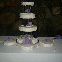 Rodriguez Wedding Four layered cake, three 8 inch round cakes, lemon, strawberry and chocolate filling, tiers seperated by wine glasses