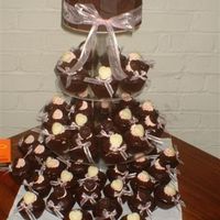 Chocolate Cupcakes 70 cupcakes 1/2 dark-1/2 white with mousse filling, handmade chocolate cups, hamdmade chocolate hearts, handtied ribbons. Top tier was...