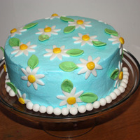 Daisy Cake 8 in yellow cake, buttercream icing, with fondant accents.