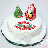 Christmas Tree And Relaxing Santa On Sofa A Christmas Celebration theme with Snowy Christmas Tree and Santa relaxing on the Sofa. Cake is mudcake with all fondant covering and...