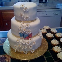 My First Wedding Cake Three tier wedding cake, cappucino buttercream, guava, and cocunut filling followed by 24 matching cupcakes.