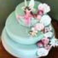 Fairy Cake This was a birthday cake for a fairy loving young lady. The fairies and flowers are gumpaste. My very first attempt at gumpaste flowers....