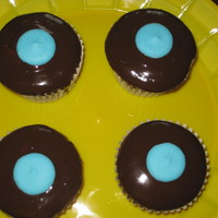 Ganache Cuppie Chocolate cupcake, peanut butter cup filling, w/ choc ganache topping and blue candy melt dot for decoration:)