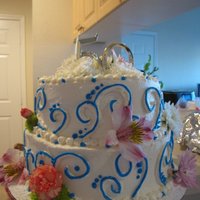 50Th Anniversary Cake white cake with strawberry filling, frosted with whipped cream frosting. Fresh flowers added per client's request