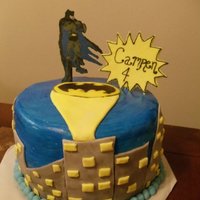 Batman Marble cake with creamcheese frosting. Batman logo and batman are made from chocolate and the buildings are fondant.