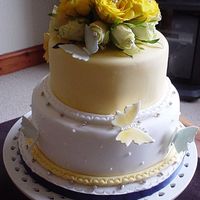 Butterfy Wedding Cake Two tier sponge cake decorated with fresh roses and sugar paste butterflies