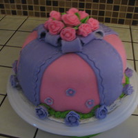 Pink And Purple This was my first "everything" cake. First time with fondant (homemade), first flowers, first piping, etc. Though it's not...