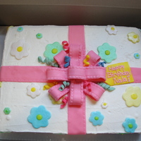 Birthday Present I made this on one of the hottest and most humid days of the year. This was my first attempt at a fondant bow. The humidity killed my bow....