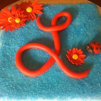 L Cake Square cake covered with fondant and sugar crystals. Decorated with fondant details.