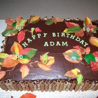 Autumn Theme 60Th Birthday Chocolate cake with chocolate ganache with coloured white chocolate leaves done on back of a real leaf
