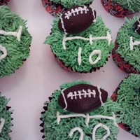 Football Cupcakes chocolate cupcakes with ganache filling, buttercream icing and the footballs are made of chocolate as well