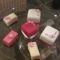 Cherry Blossom Petit Fours Mix of rolled fondant and fondant-dipped petit fours, decorated with gumpaste cherry blossoms and some royal icing piping. The bases...