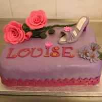 Cake Whit Roses And Shoe A small cake for my daughter in law.Chocolate cake, and hazelnut cake, bisquiscakeFill light ganasche mixed with daim and a mousse of...