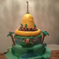 Courious George Cake This cake was made for my Cousins son's first B-day. The Yellow hat is RKT and the rest of the details are fondont. The trees are mini...