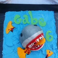 Shark specific request by the birthday boy, he wanted a scary shark, eating a fish with blood. The shark is cereal treats and the rest is cake.