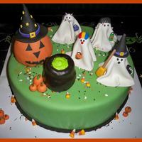 Halloween Birthday 14" chocolate cake with chocolate whipped buttercream filling. Covered in fondant. Cauldron and pumpkin are rice krispie treats. All...