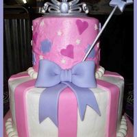 Princess 5" and 9" french vanilla cake with strawberry filling. Covered in buttercream with fondant decorations. Wand and tiara made from...