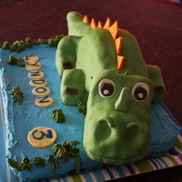 Dinosaur Cake Dinosaur Cake, covered in Green Fondant. Tummy is chocolate cake and the head, feet and tail are rice treats