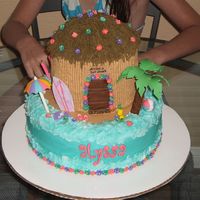 Alyssa's Surf Shack This is a 10" round covered in buttercream, with (3) 6" rounds for the tiki hut. I let one of the 6" dome on top to get the...