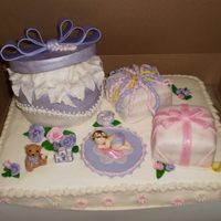 Baby Shower Gifts Baby shower cake with fondant covered gifts and fondant/gumpaste accessories and flowers. The hat box was chocolate andes mint cake and...
