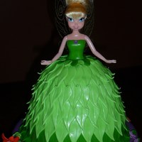 Tink! Tinkerbell doll w/ carved cake skirt - Vanilla Cake w/ Peanut Butter Buttercream covered in MMF leaves. Base cake is Chocolate Cake w/...