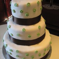 Green Flowers A 12,9,6 wedding cake with fondant cutout flowers :)