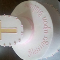 Baptism Baby Girl Round bottom cake with oval cake on top. Oval is bevelled to better show the cross.